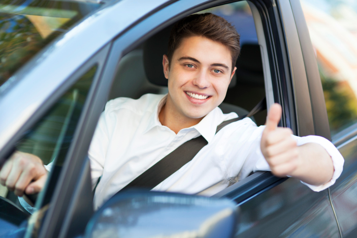 Man in a car with thumbs up
